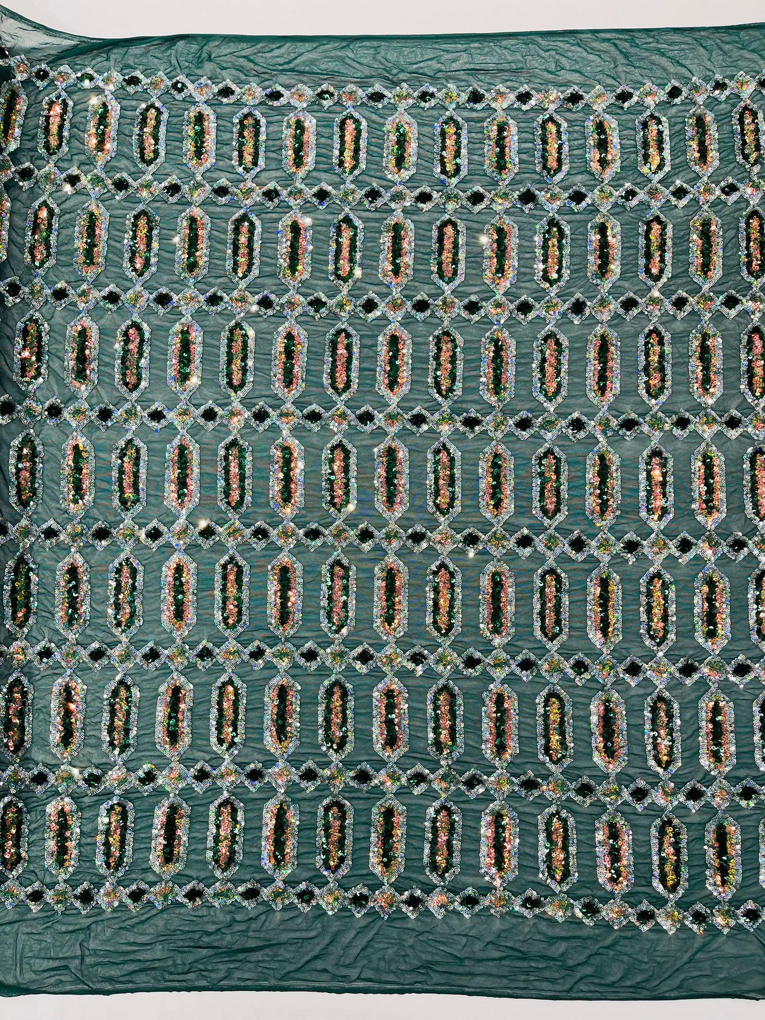 Emerald/Silver multi color iridescent Jewel sequin design on a Green 4 way stretch mesh fabric.