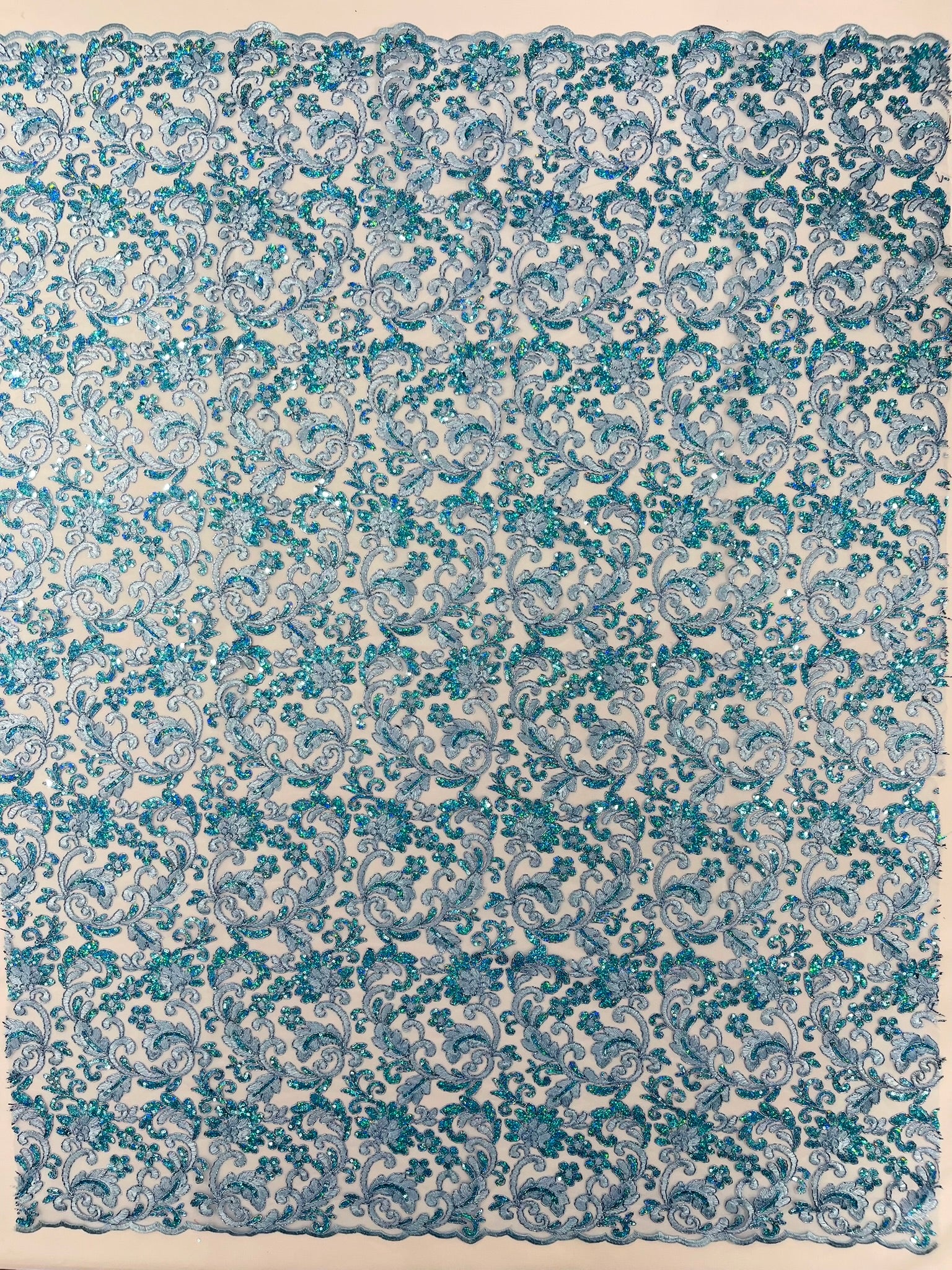 Metallic Corded Lace Design Embroidered With Holographic Sequins on a Mesh 54” Wide.