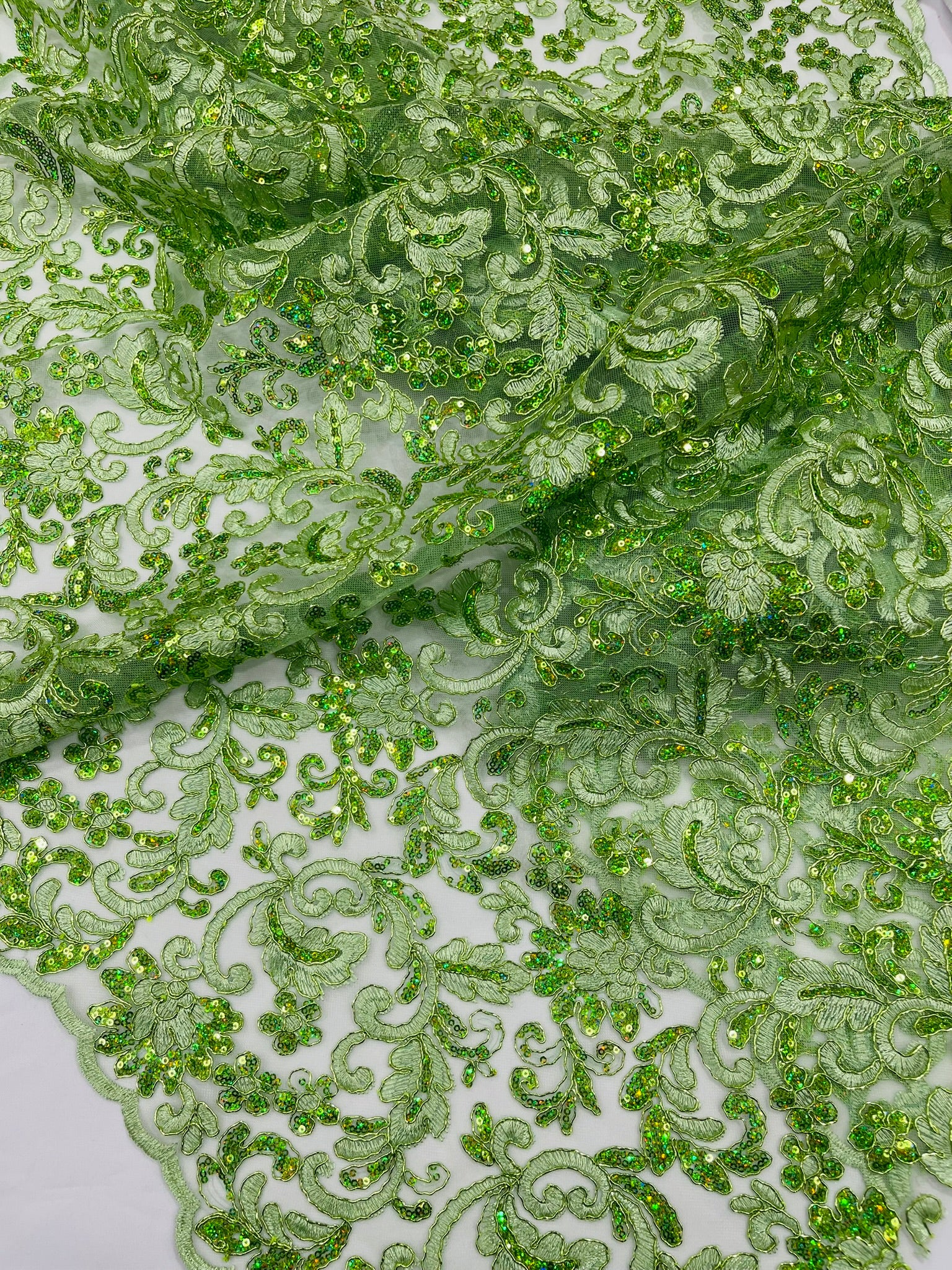 Metallic Corded Lace Design Embroidered With Holographic Sequins on a Mesh 54” Wide.