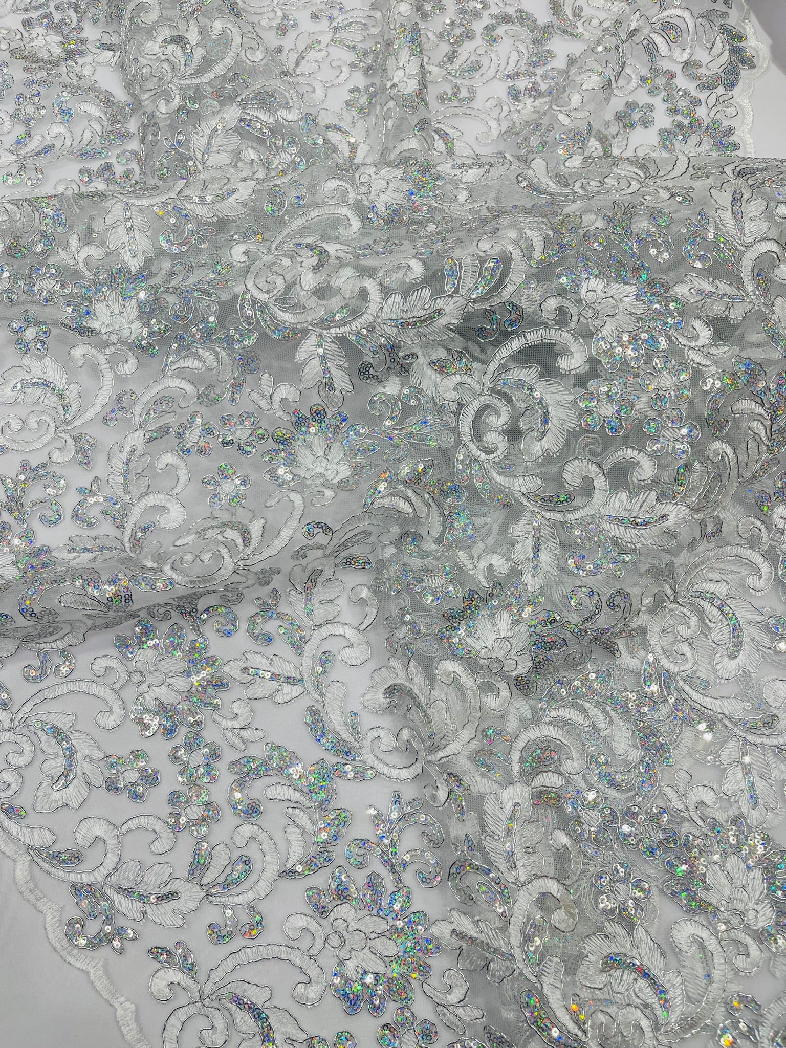 Metallic Corded Lace Design Embroidered With Holographic Sequins on a Mesh 54” Wide.