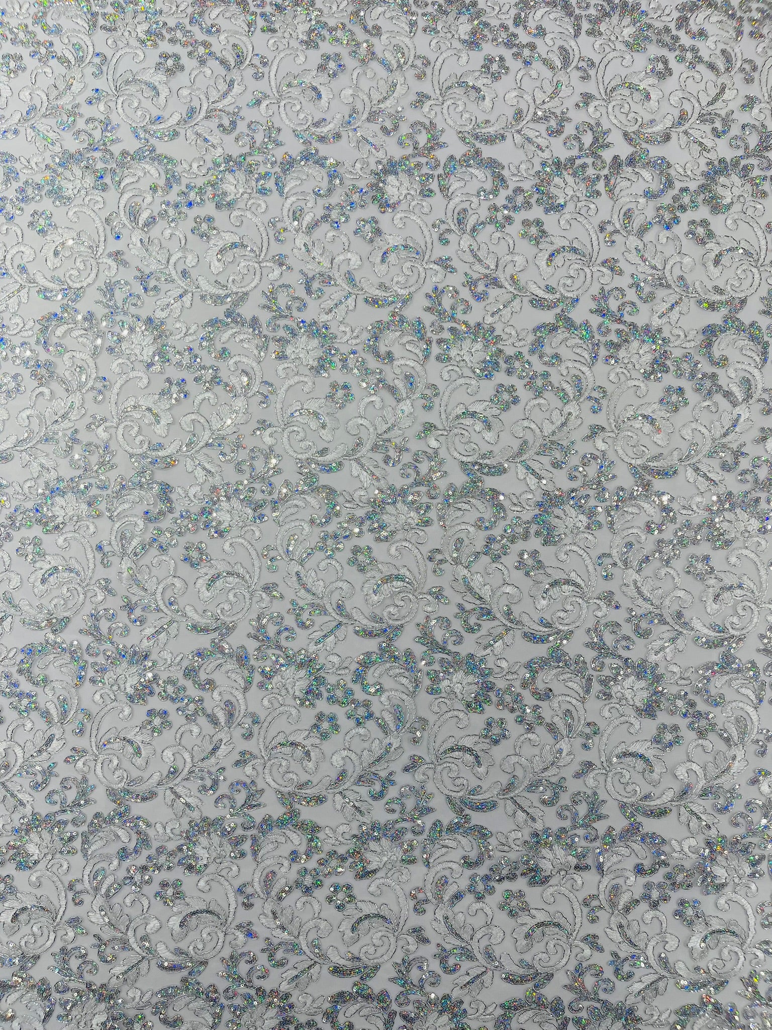 Metallic Corded Lace Design Embroidered With Holographic Sequins on a Mesh 54” Wide.